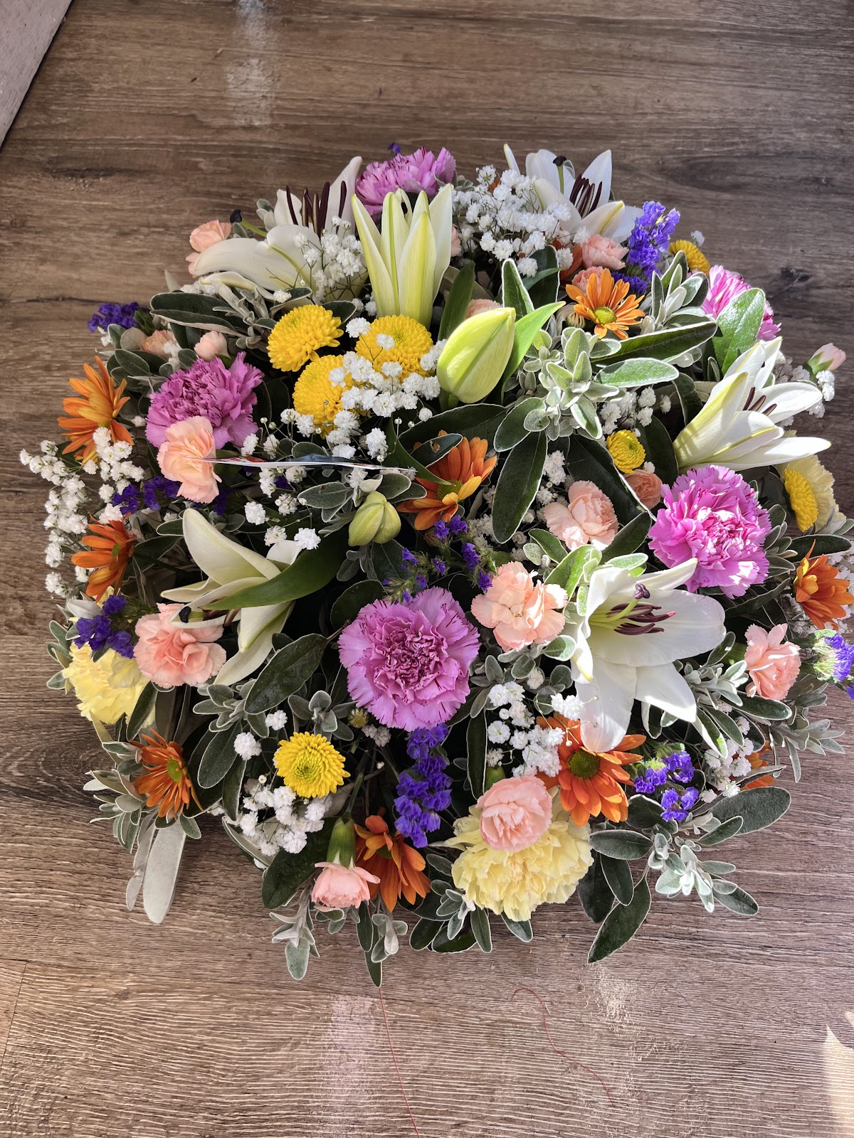 A mixed bouquet from Lisnagry Flowers — lilies, carnations and seasonal blooms, as shown on their Google listing